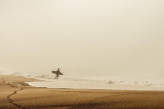 Immagine di Surfing su una spiaggia nebbiosa