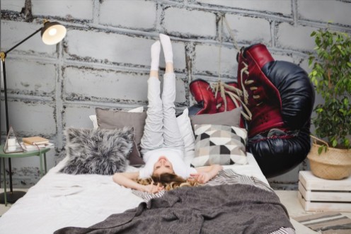 Picture of A pair of old boxing gloves hanging on white brick wall background