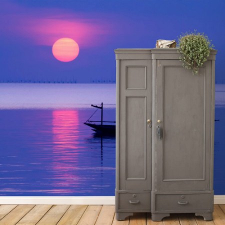 Afbeeldingen van Peaceful Morning at sunrise with small boat silhouette in the beach