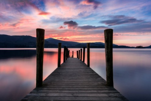 Picture of Stunning vibrant pink and purple sunset on a beautiful evening at Ashness Jetty Derwentwater Lake District UK