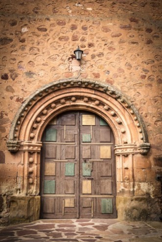 Picture of Ancient wooden door on a stone made wall