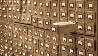 Bild på Old library or archive reference catalog with one opened card drawer Database and knowledge catalogue concept