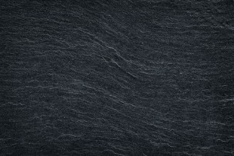 Bild von Black slate stone background or texture