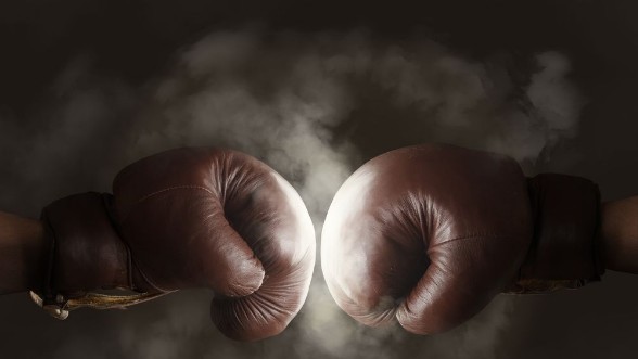 Picture of Two old brown boxing gloves hit together