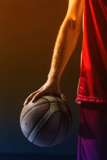 Picture of Close up on basketball held by basketball player