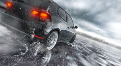 Afbeeldingen van Fast Car driving fast on wet Road water is splashing around