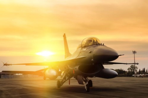Pilt F16 falcon fighter jet parked  on sunset  background 