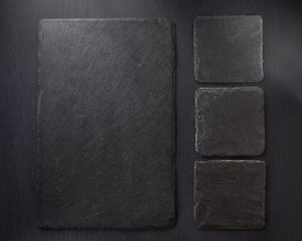Bild på Slate stone at wooden background