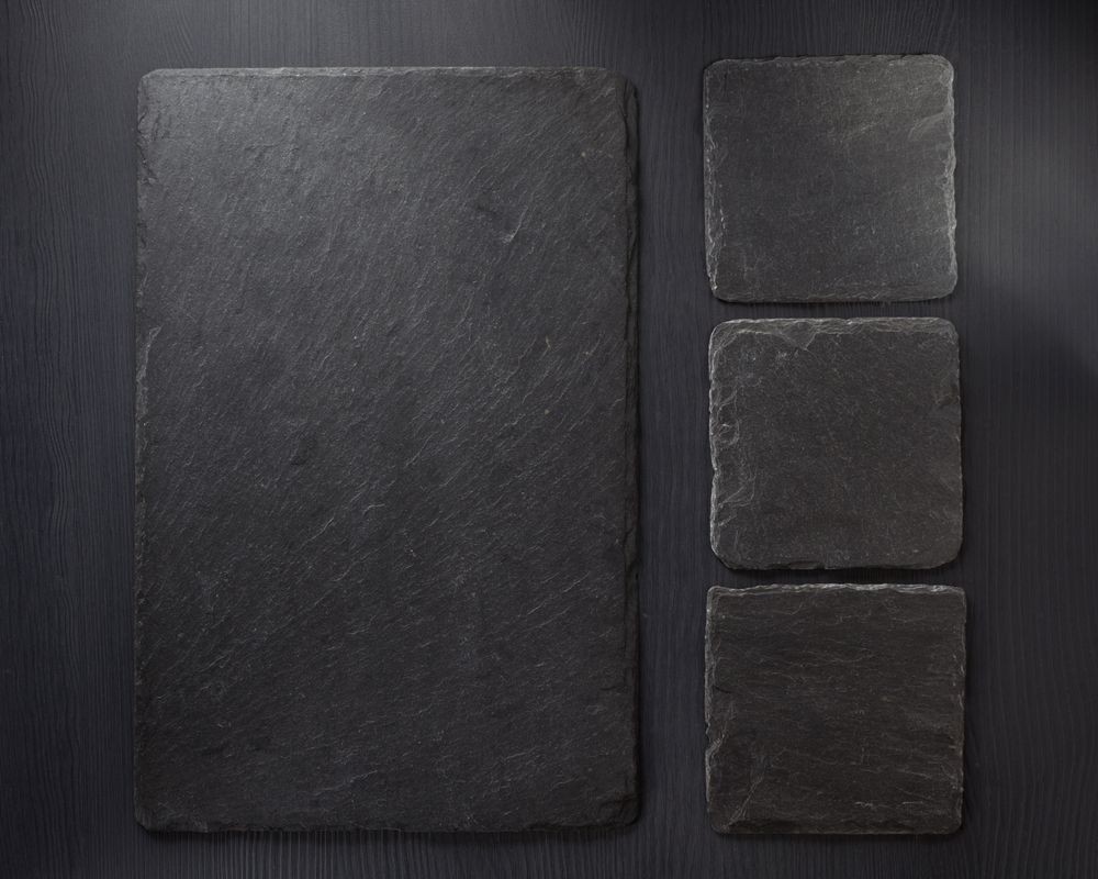 Bild på Slate stone at wooden background