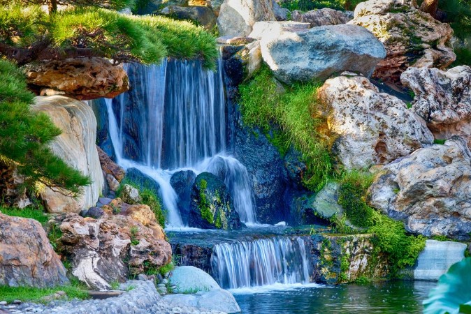 Image de A small waterfall in a garden