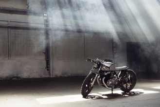 Picture of Motorcycle standing in dark building in rays of sunlight