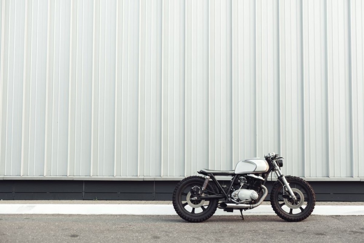 Image de Motorcycle standing in dark building in rays of sunlight