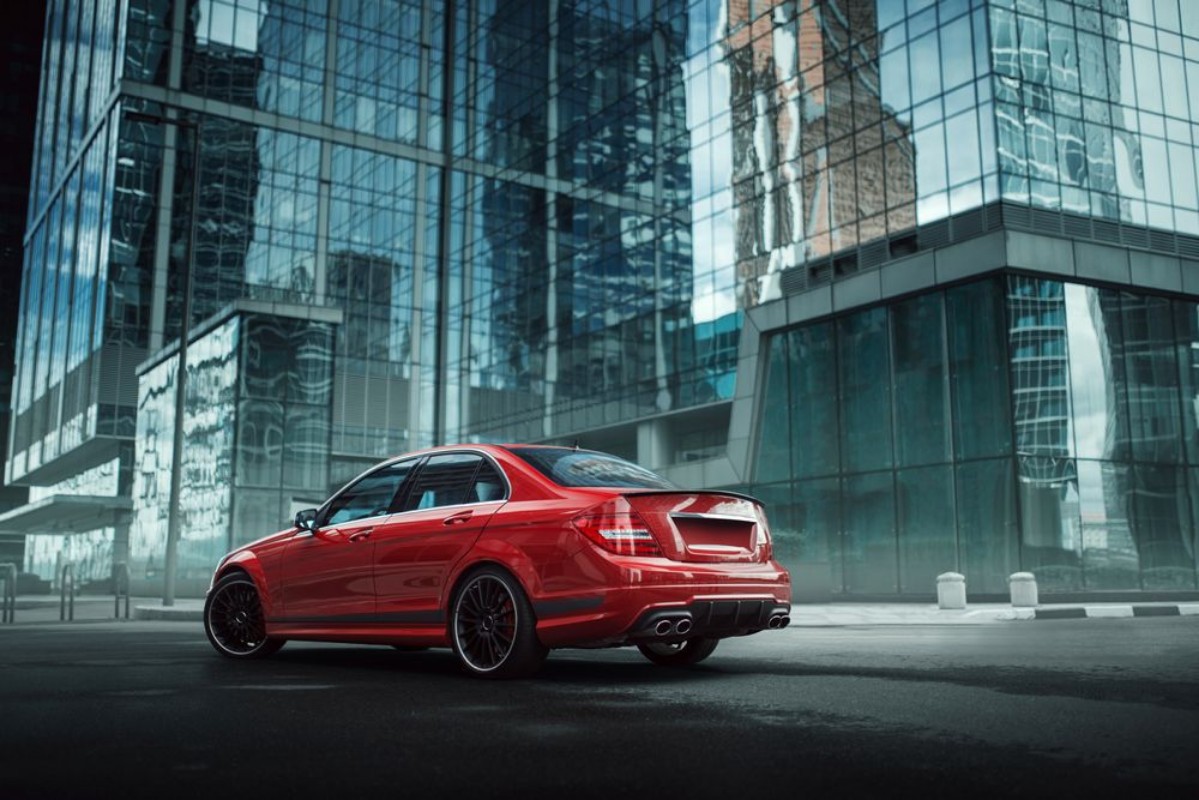 Picture of Red car stay on asphalt road in the city at daytime