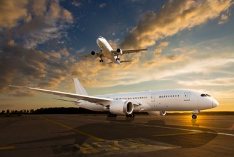 Picture of White passenger airplane on airport runway during sunset And aircraft in the sky