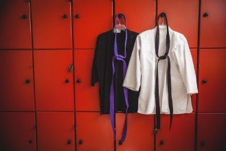 Pilt Two karate uniforms hanging on locker