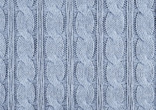 Obrazek Blue knitted textured background with a pattern closeup