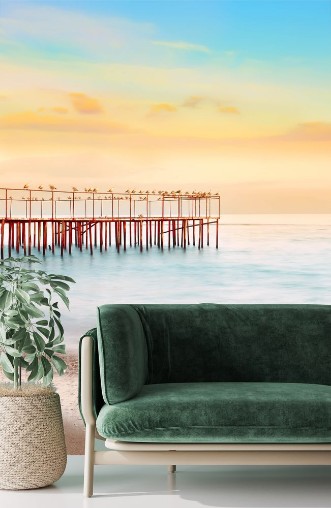 Picture of Wonderful evening by the sea Long exposure blurred water waves dashing on the shore the old pier with seagulls soft focus