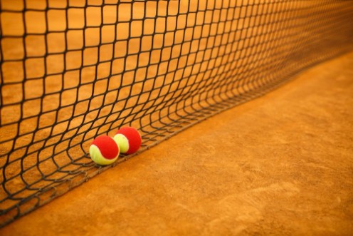 Picture of Tennis red ball on a clay tennis court orange color