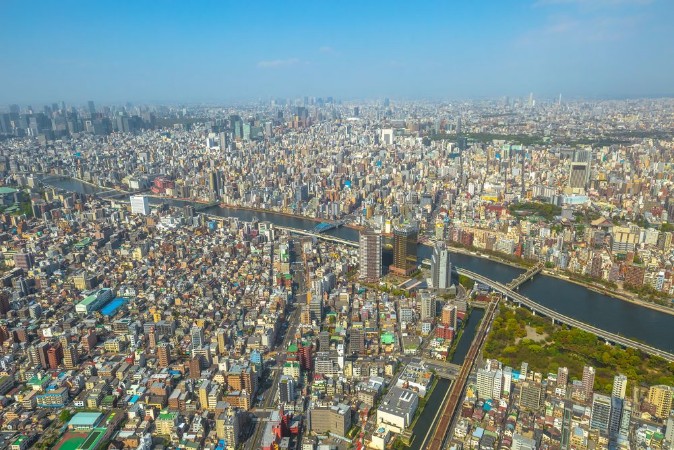 Picture of Aerial view of Tokyo city skyline with Asahi Beer Hall Asahi Flame o Golden Turd Sumida River Bridges and Asakusa area from Tokyo Skytree observatory Daytime Tokyo Japan