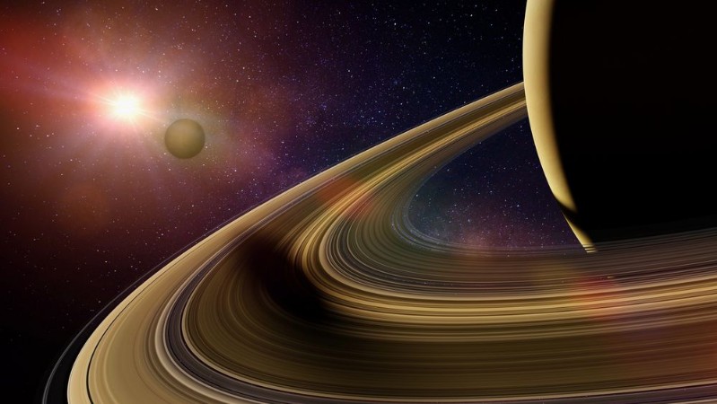 Saturns moon Enceladus casts shadow on planet Saturns rings photowallpaper Scandiwall