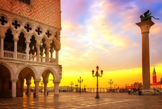 Picture of Famouse Doge palace column with winged lion and San Marco square at sunrise Venice Italy retro toned