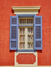 Picture of Elegant vintage window on orange house wall