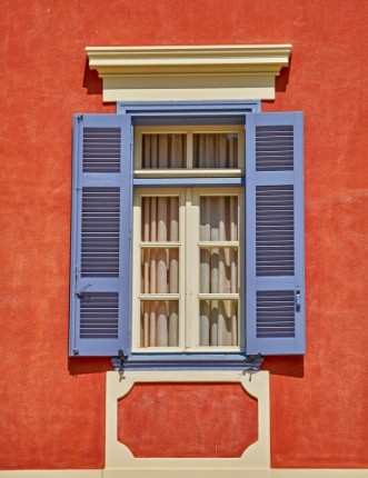 Picture of Elegant vintage window on orange house wall