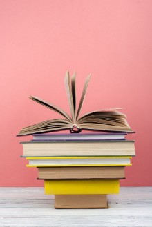 Bild på Open book hardback colorful books on wooden table Back to school Copy space for text Education business concept