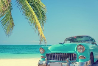 Image de Classic car on a tropical beach with palm tree vintage process