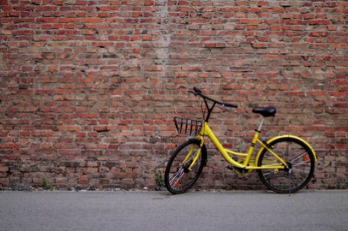 Picture of Yellow Bicycle by the Brick Wall