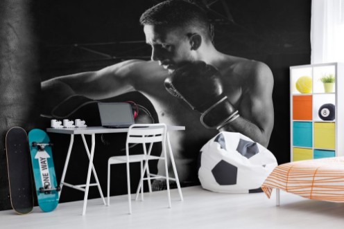 Picture of The fighter of mixed martial arts beats on the bag with his elbow