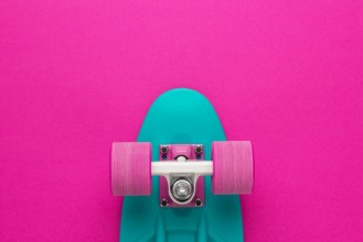 Afbeeldingen van Plastic mini cruiser board on deep pink with background with copy space