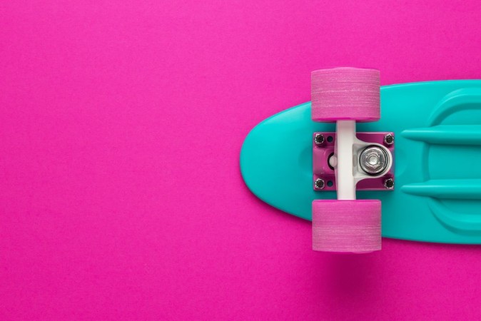 Picture of Plastic mini cruiser board on deep pink with background with copy space