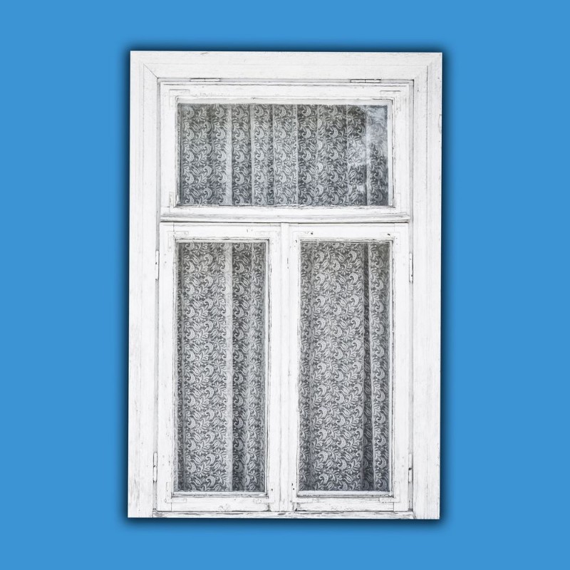 Picture of Old white paint wooden window isolated on blue