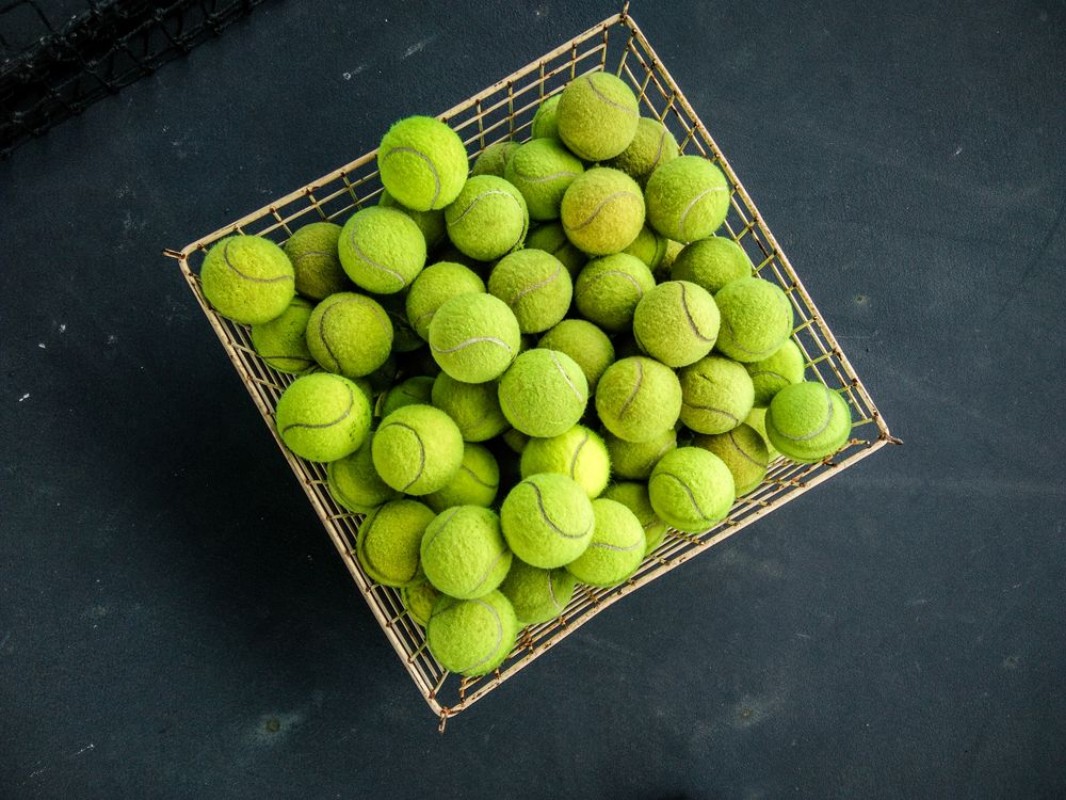 Picture of Top view of green tennis balls in a busket