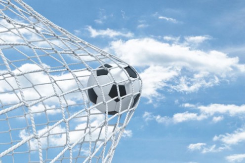Picture of 3d rendering of a football ball caught in a white net from the gates on a sky background