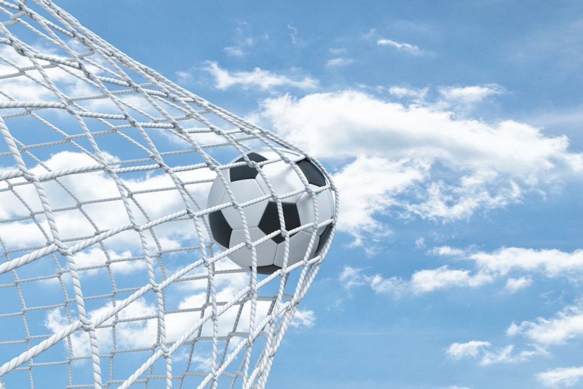 Picture of 3d rendering of a football ball caught in a white net from the gates on a sky background