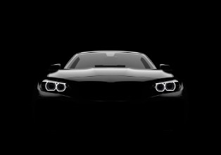 Afbeeldingen van Front view of a generic and brandless modern car on a black background