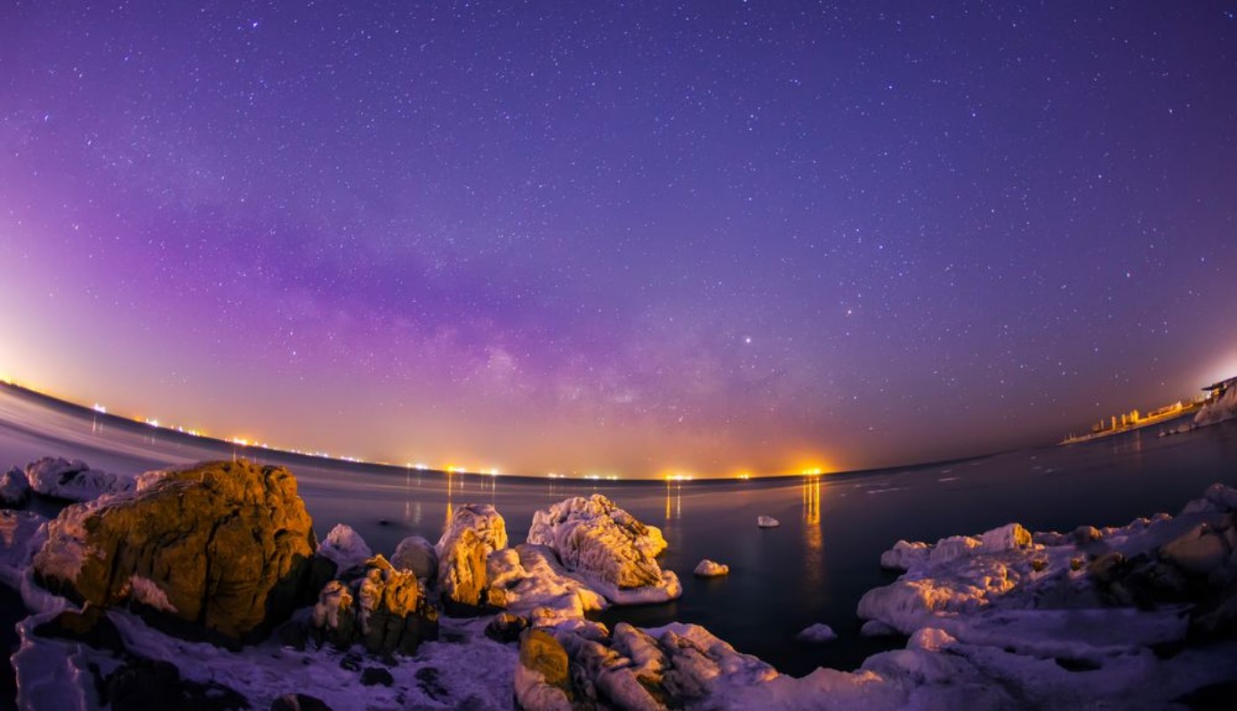 Picture of On winter nights snow and ice cover the rocks by the sea