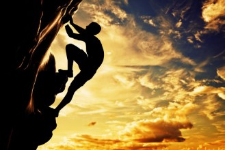 Picture of A silhouette of man climbing on mountain at sunset Adrenaline