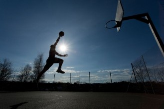 Image de Basketball player silhouette taking off to slam dunk