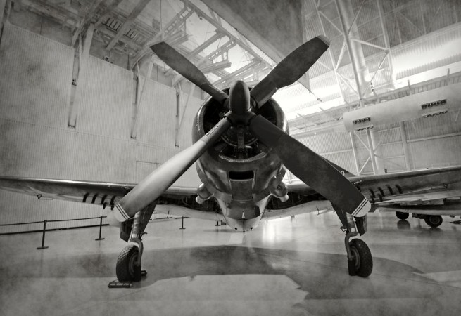 Old airplane in a hangar photowallpaper Scandiwall