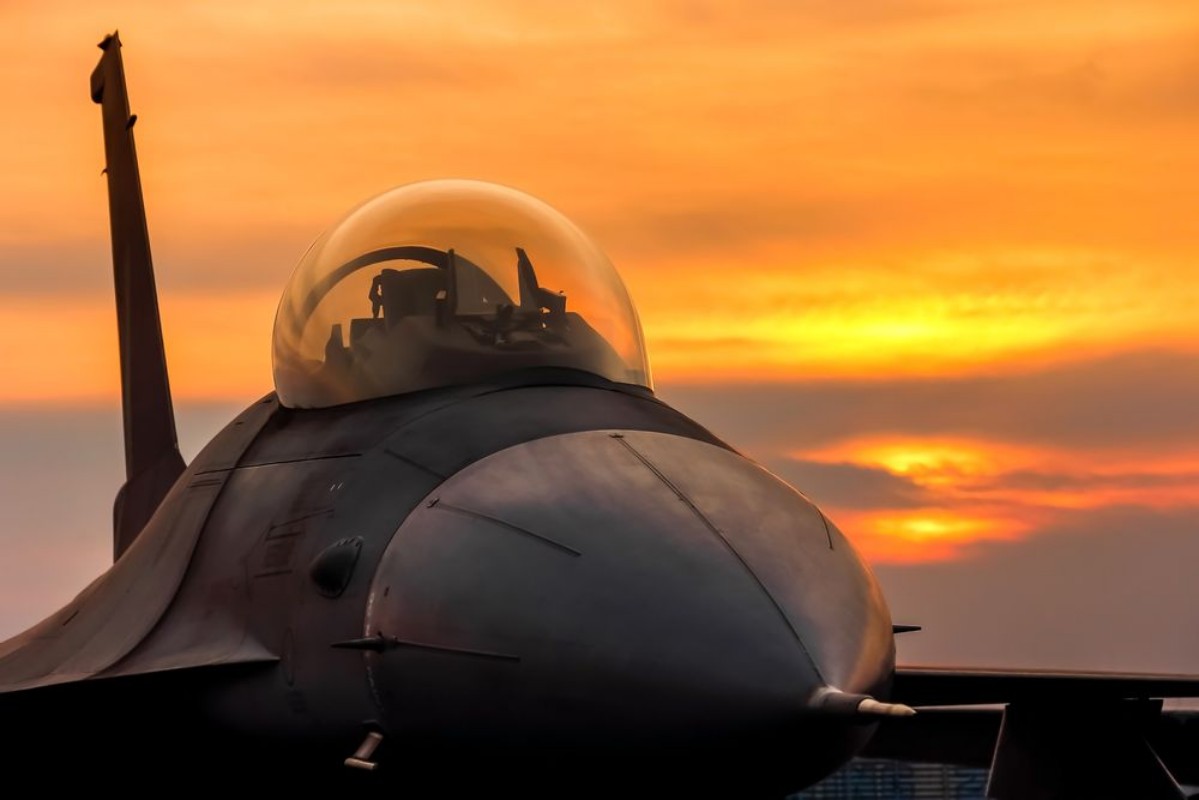 Picture of F16 falcon fighter jet on sunset  background