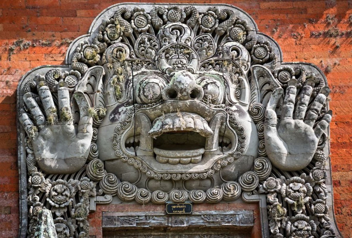 Picture of Carvings depicting demons or gods above the entrance to the temp