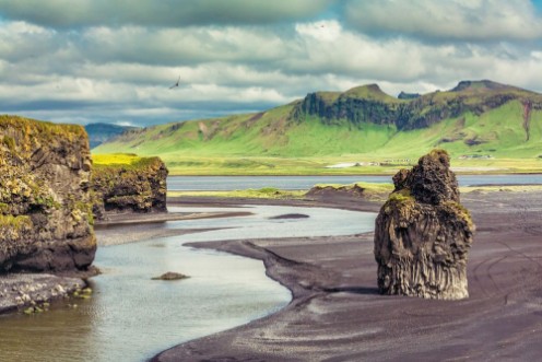 Picture of The black sand beach with typical Icelandic mountain landscapes