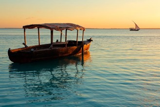 Picture of Wooden boat on water at sunset Zanzibar island
