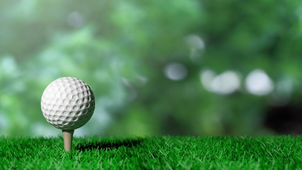 Picture of Golf ball on green turf and green background