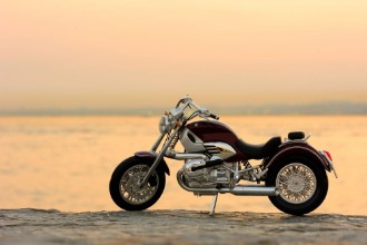 Bild på Motorcycle on the rocks in sunset and golden hours