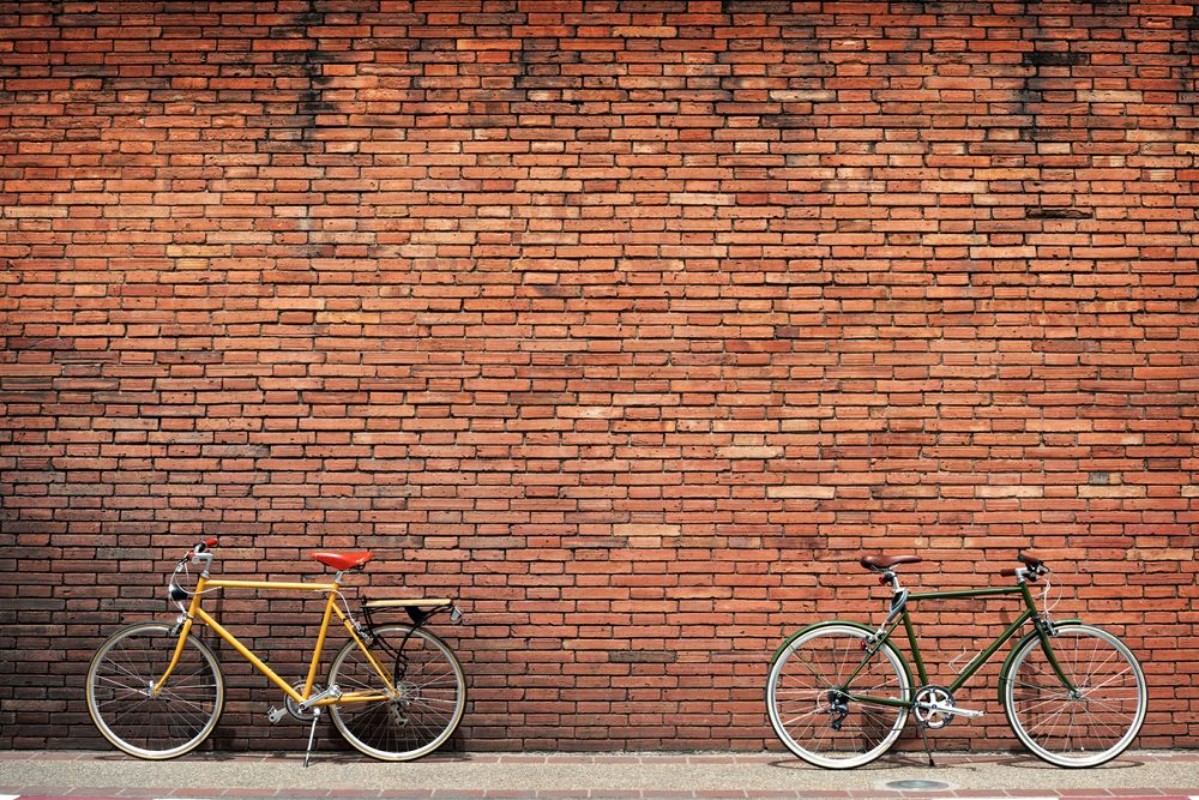 Picture of Retro bicycle on roadside with vintage brick wall background