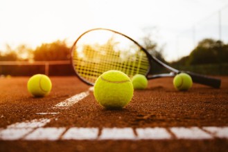 Image de Tennis balls with racket on clay court